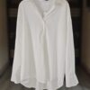 A timeless white button-down shirt made from lightweight fabric with a relaxed fit and a flattering high-low hem. Perfect for work, casual days, or layering.